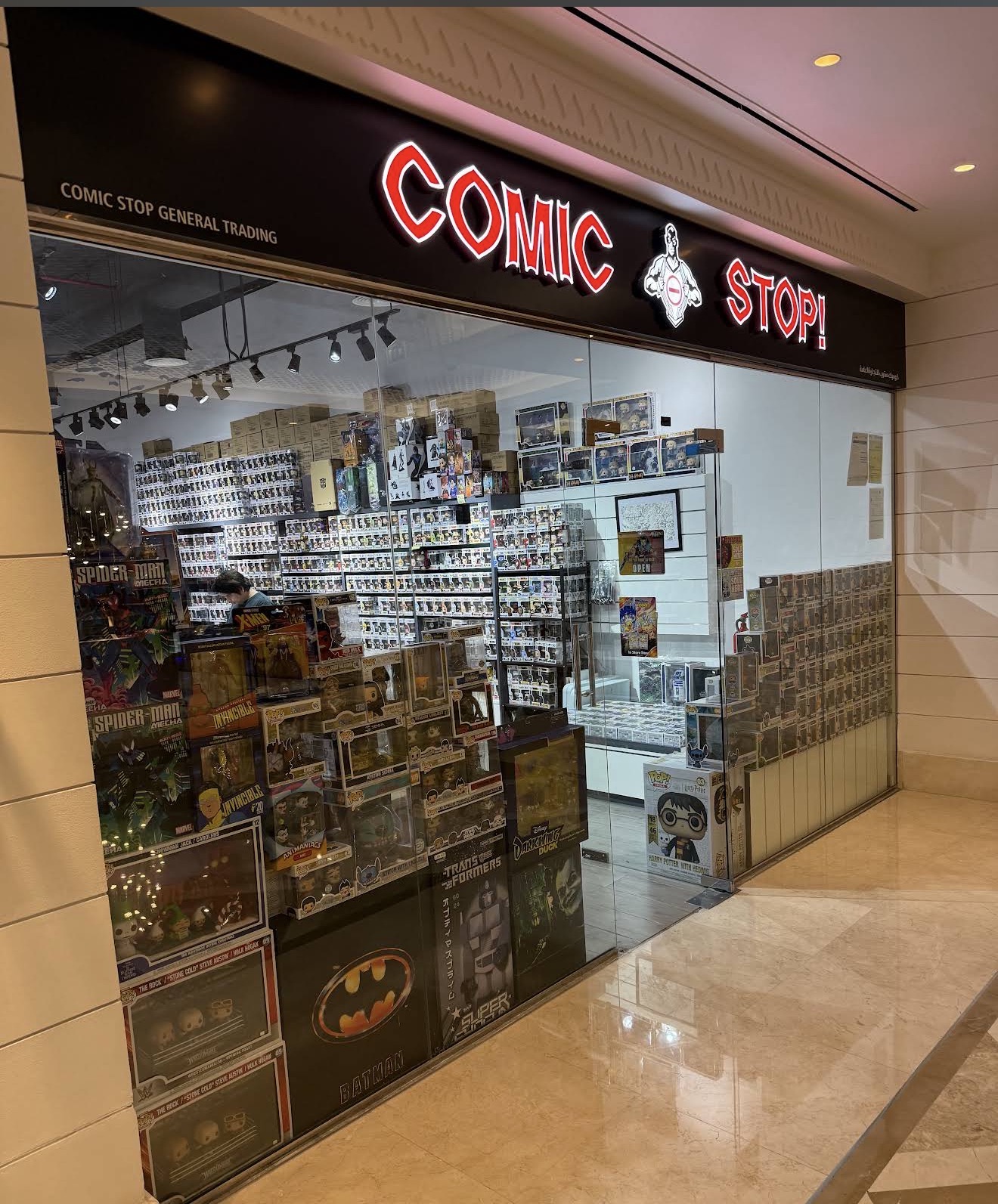 Comic Stop illuminated storefront and collectibles displays