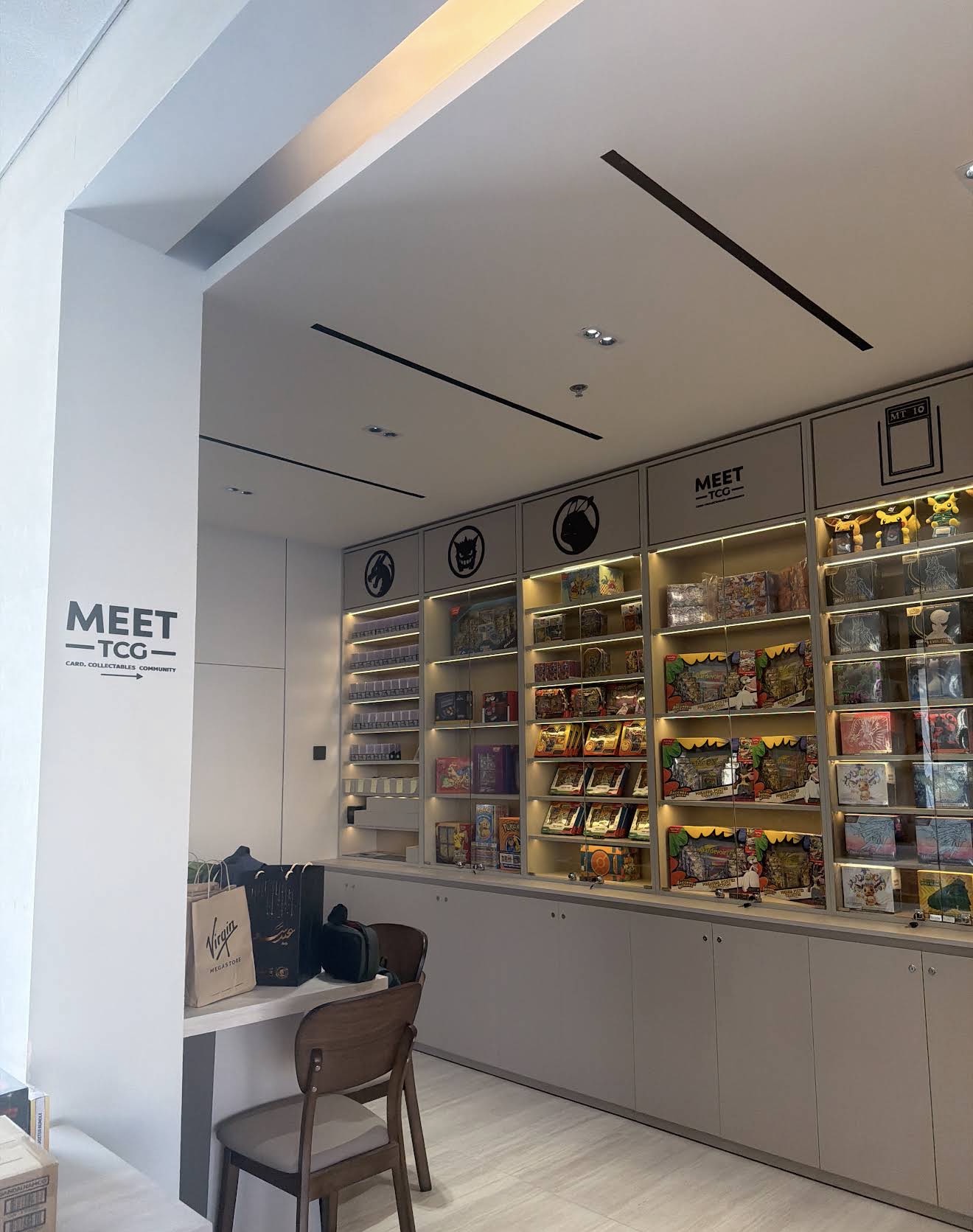 Branded MEET TCG interior with trading-card displays